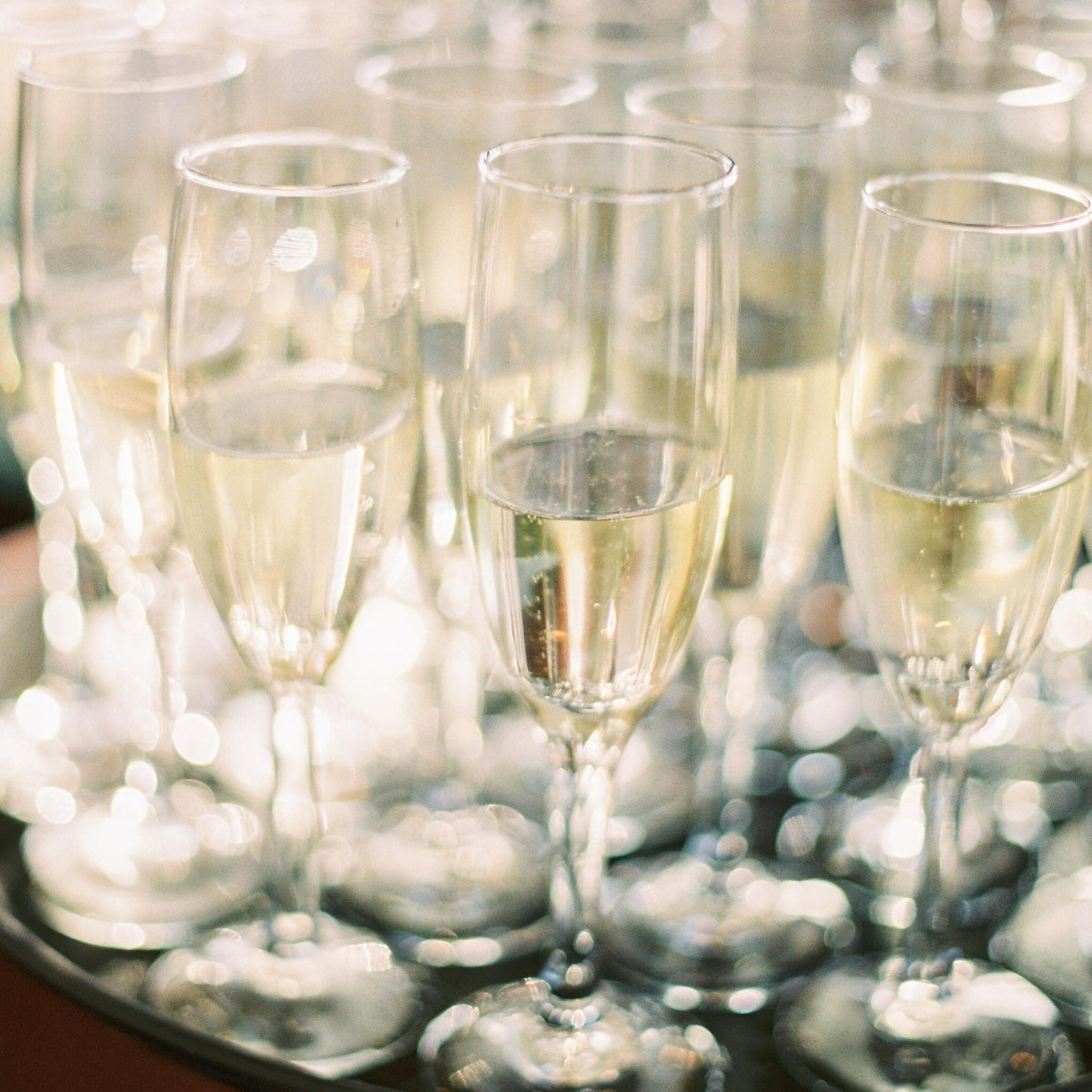 Champagne glasses on a black tray